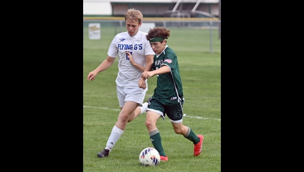 ASHTON ENCISO (#2) battles a Gladwin player to send a pass to Tony Holstine for Pinny’s first goal last Tuesday.