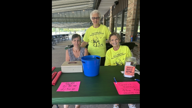 THERESA HELM, JUDY FENWICK AND LYNN BEGRES (l to r) sold 50/50 tickets and raffle tickets for the quilts that will be raffled off on December 4th.