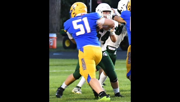 Max Meehleder (#64) defends against the pass rush on Friday night at Harrison.