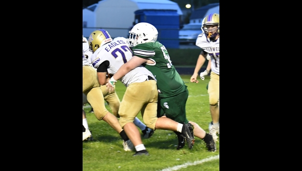 OWEN MURRAY (#52) takes down the Eagles ball carrier at the line in last Friday’s Homecoming game