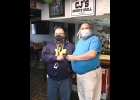 STANDISH-STERLING CENTRAL High School Principal Gary Roper accepts a stack of gift cards from CJ’s Sports Grill owner Clif Holland. After seeing last week’s news about a donation from a PHS Alumnus for deserving families, an SSC Grad followed suit, providing 18 gift cards to Standish-Sterling area families and another 7 for Pinconning Area families. The Christmas Spirit of helping deserving neighbors is alive and well in Northern Bay and Arenac Counties.          --Journal Photo